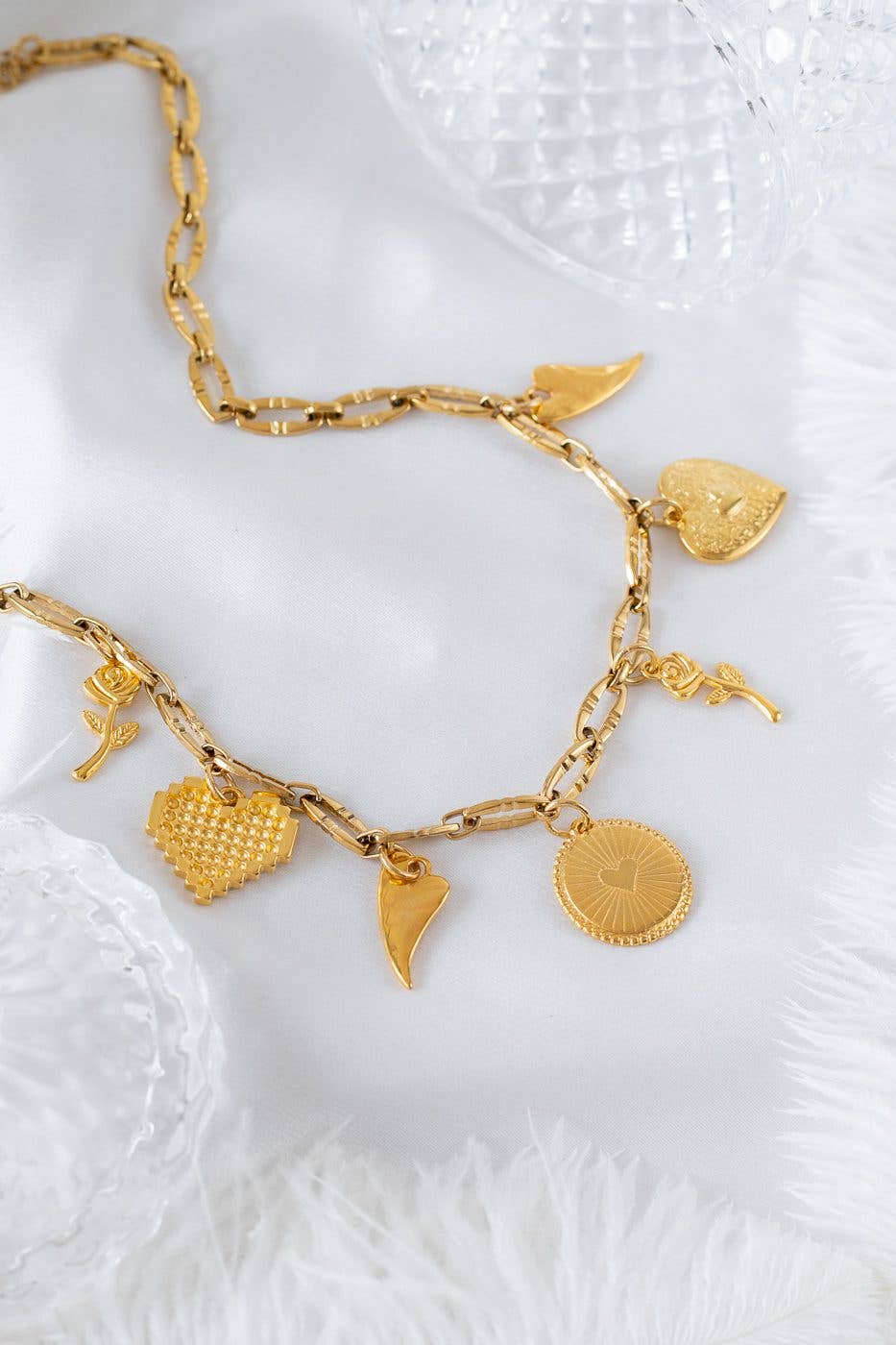 Gold charm necklace with hearts and roses